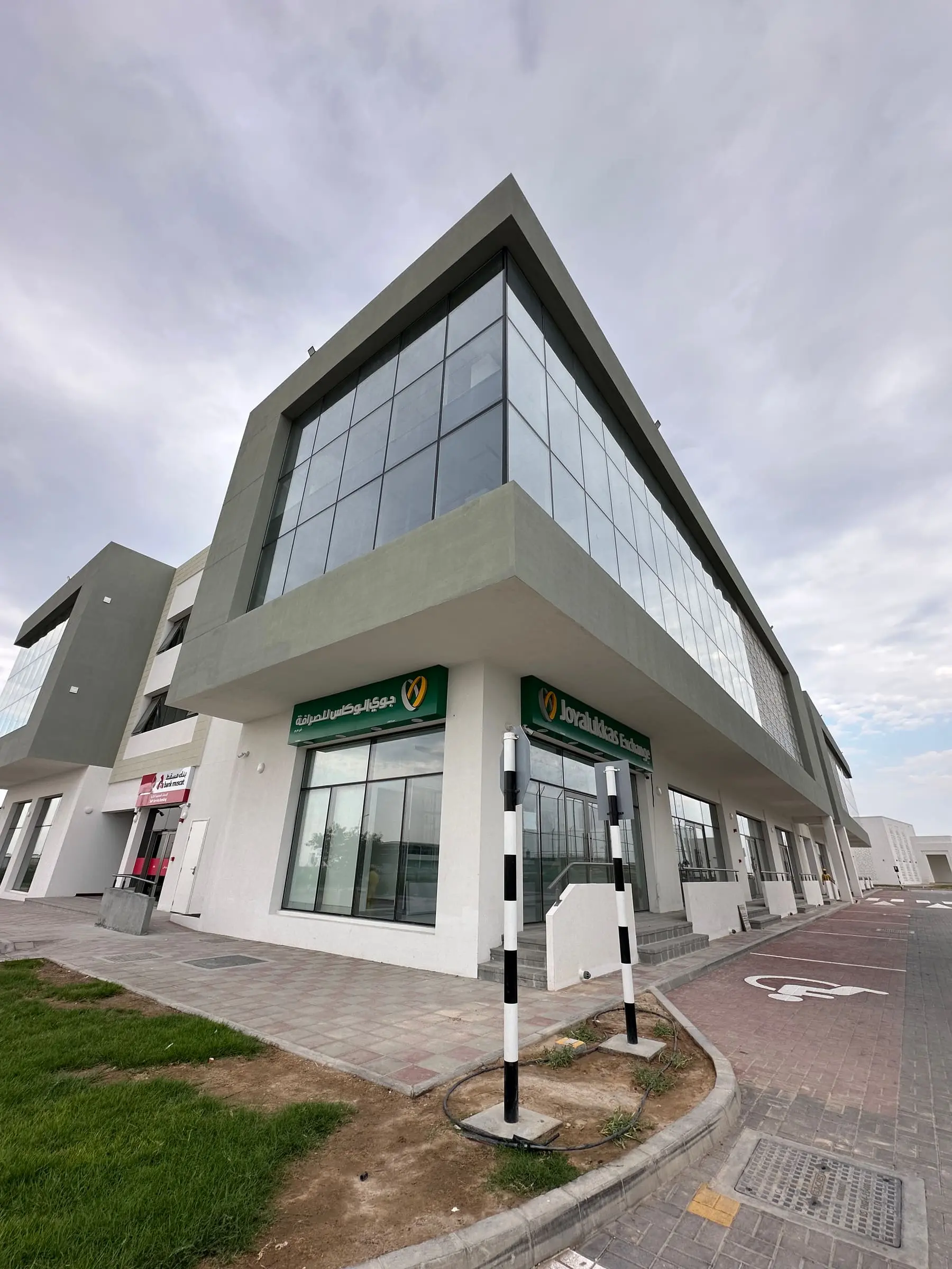 Commercial building with Joyalukkas Exchange and the Bank Muscat ATM