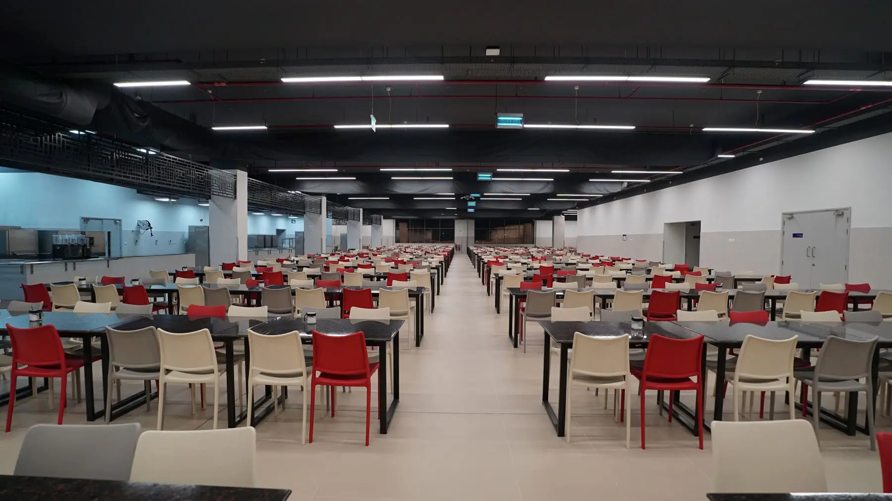 Safi Dining Hall with rows of tables and red chairs