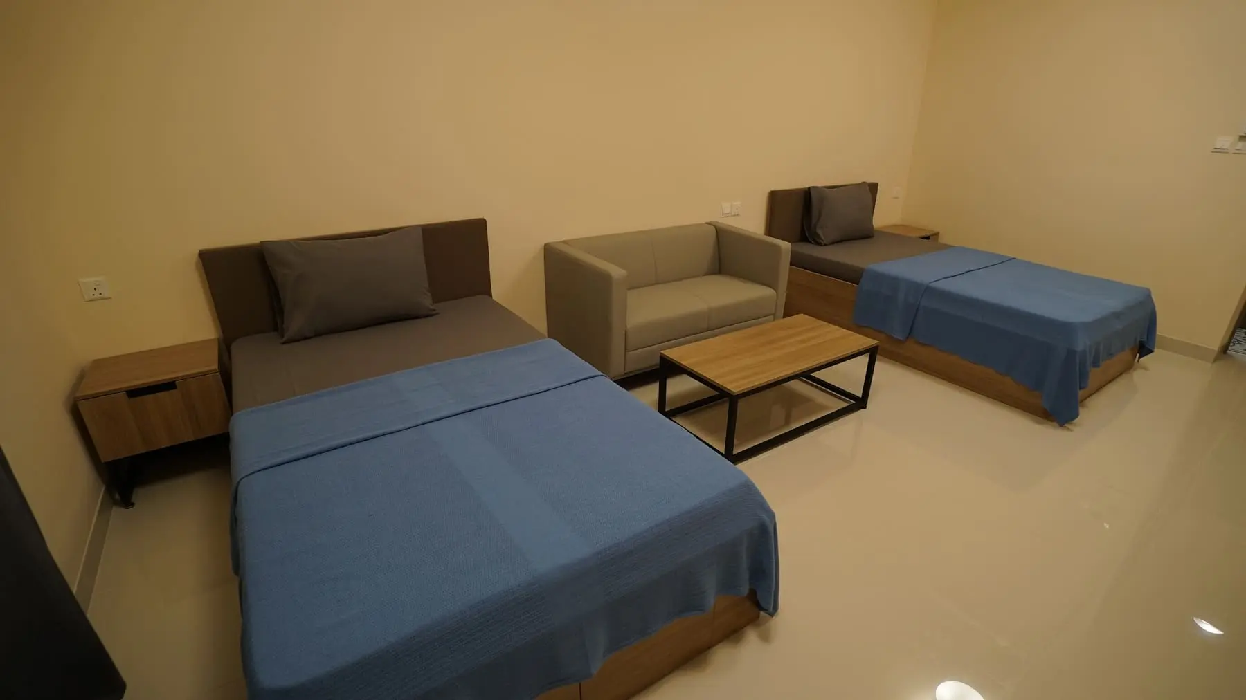 Double Premium room with two beds, sofa and coffee table