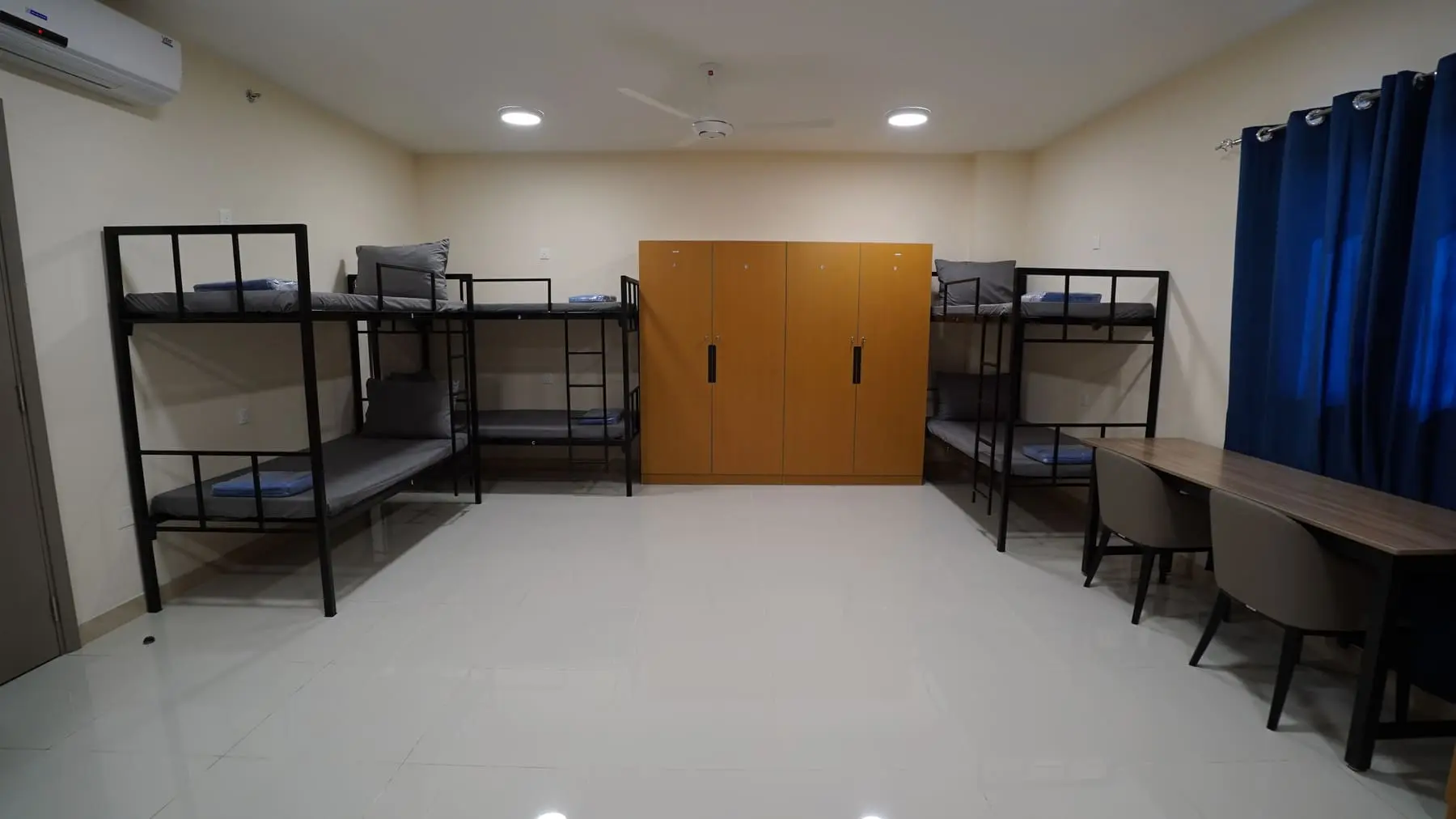 Shared room with steel bunk beds and wardrobes