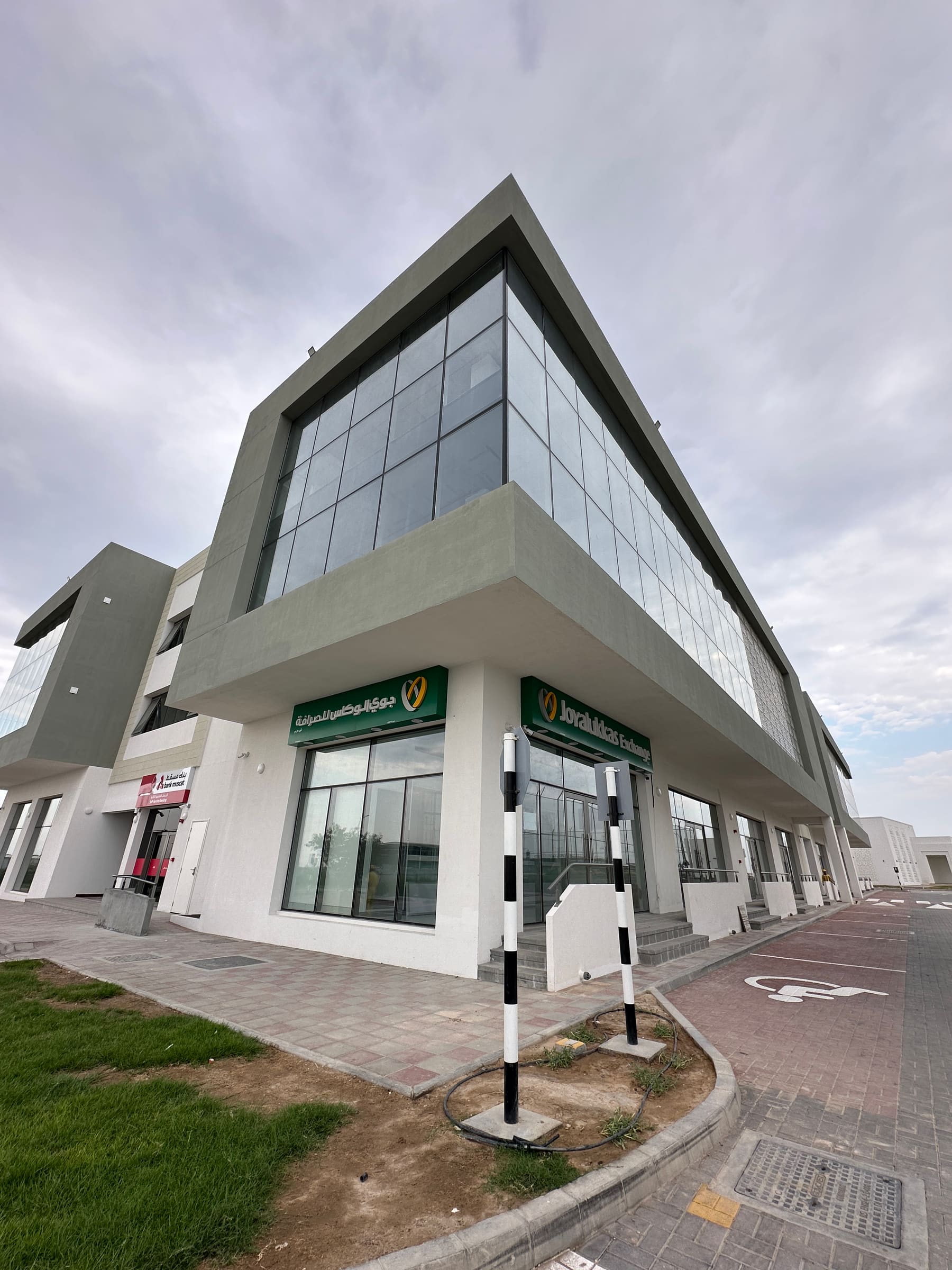 Commercial building with Joyalukkas Exchange and the Bank Muscat ATM