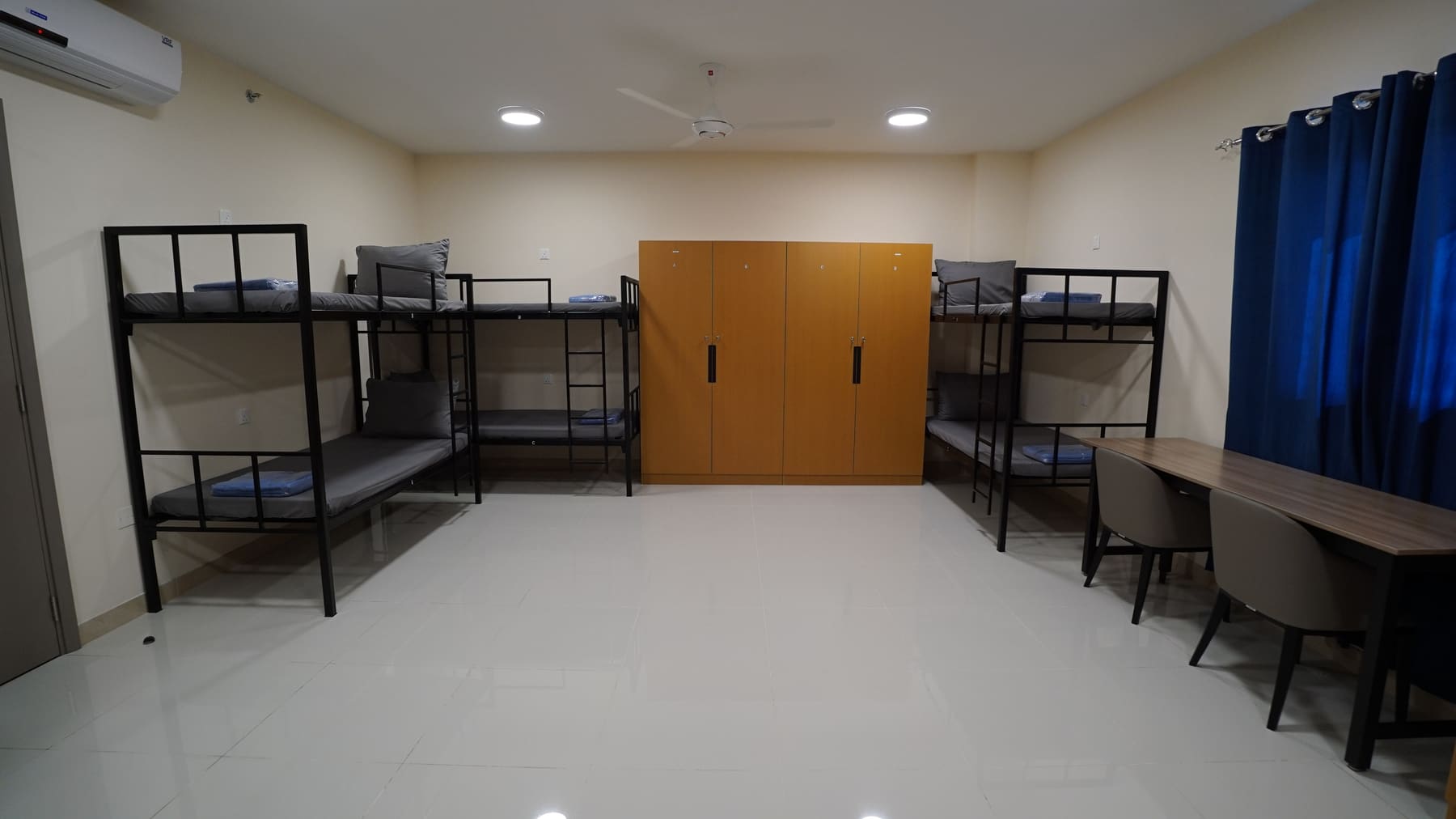 Shared room with steel bunk beds and wardrobes