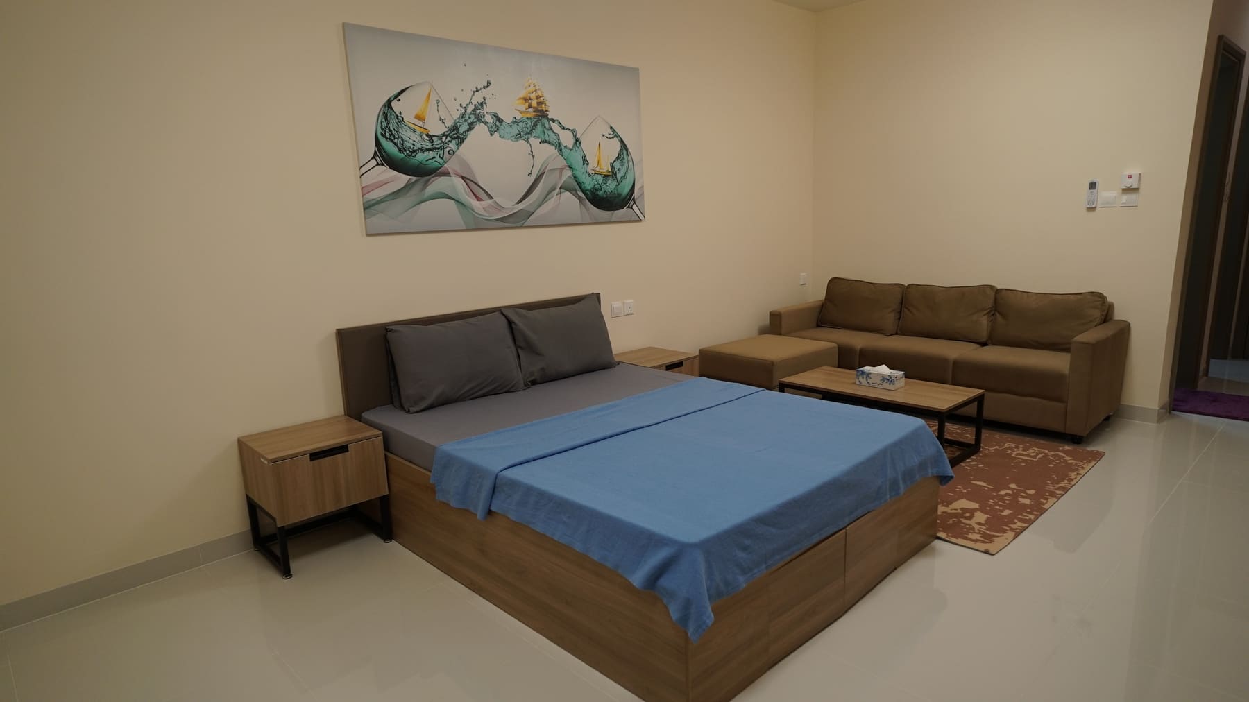Single Premium room with queen bed, sofa and coffee table